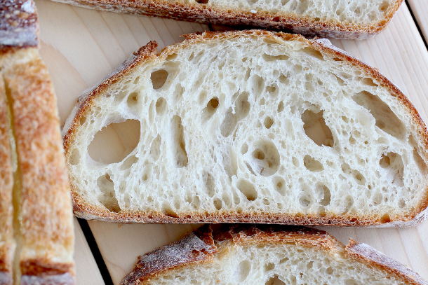 Sourdough bread slices on a wooden cutting board