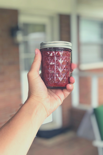 Hand holding a jar of easy and healthy strawberry chia seed jam