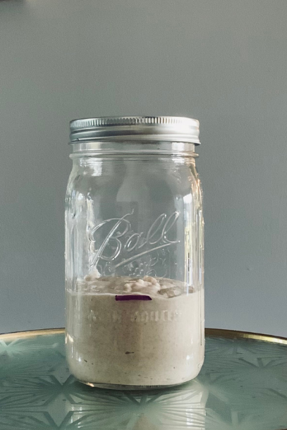 Freshly fed sourdough starter in a mason jar