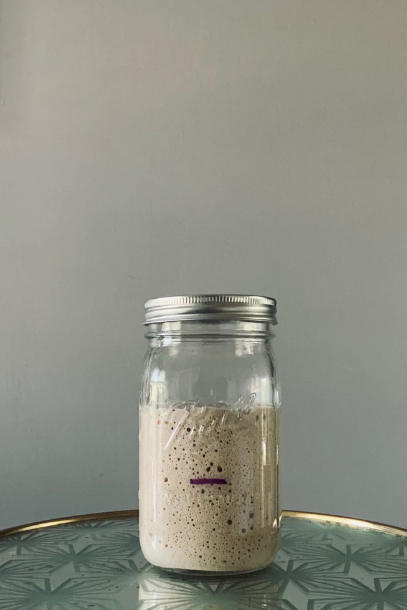 Mason jar with doubled sourdough starter in it